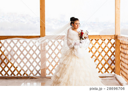 Young bride with the flower bouquet in winter time Young bride with the flower bouquet in winter time 28696706