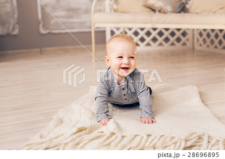 Laughing Baby Boy Lying On Tummy At Home Laughing Baby Boy Lying On Tummy At Home 28696895