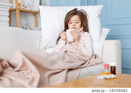 Sick pleasant girl lying on the sofa 28708082