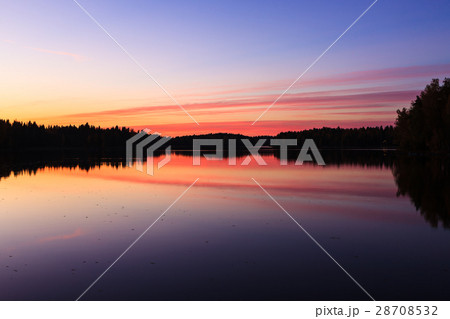Serene view of calm lake and sunset clouds 28708532