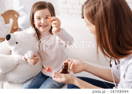 Joyful cute girl taking pills 28708994