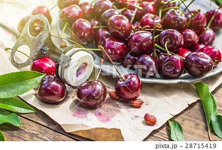 Cherries and old stone remover closeup 28715419
