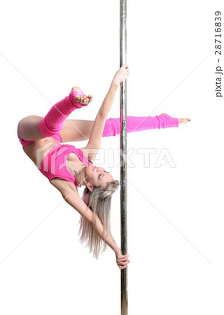 Young pole dance woman make twisted grip handspring isolated Stock