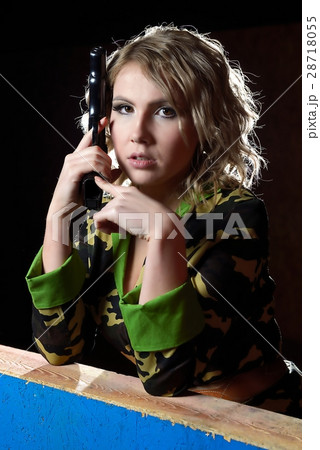 Beautiful blonde girl in military khaki shirt with gun Beautiful blonde girl in military khaki shirt with gun 28718055