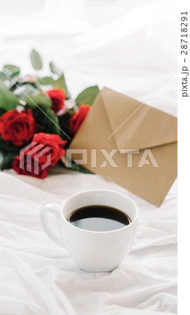 cup of coffee and a bouquet of red roses, envelope cup of coffee and a bouquet of red roses, envelope 28718291