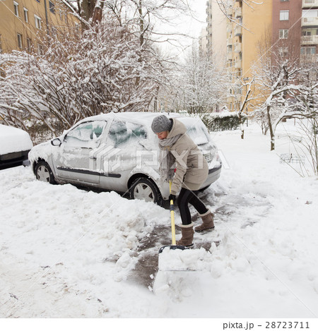 Independent woman shoveling snow in winter. Independent woman shoveling snow in winter. 28723711