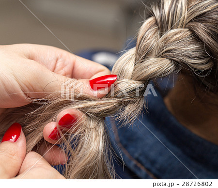 braided pigtails in the beauty salon 28726802