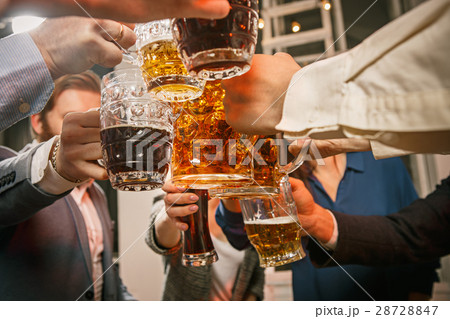 Group of friends enjoying evening drinks with beer Group of friends enjoying evening drinks with beer 28728847