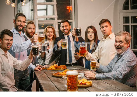 Group of friends enjoying evening drinks with beer Group of friends enjoying evening drinks with beer 28731010