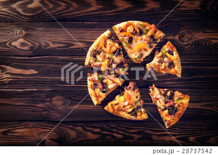 Slices of homemade pizza on cardboard with basil Slices of homemade pizza on cardboard with basil 28737542