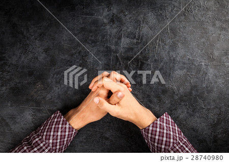 Male hands on dark background 28740980