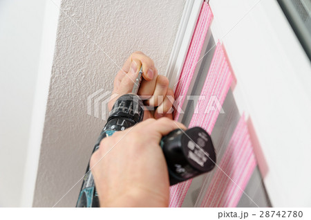 Installing fabric roller blinds. 28742780