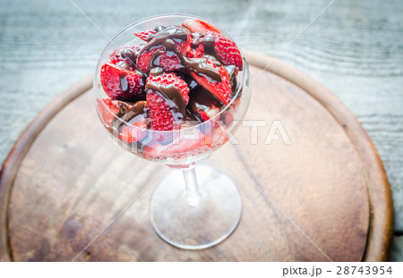 Fresh strawberries under chocolate topping  28743954