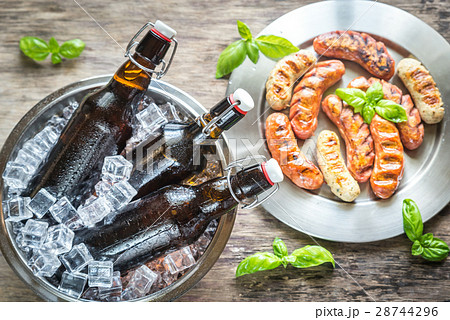 Grilled sausages with bottles of beer Grilled sausages with bottles of beer 28744296