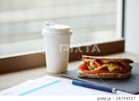 salmon panini sandwich and cup of drink at cafe salmon panini sandwich and cup of drink at cafe 28749557