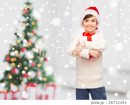smiling happy boy in santa hat with gift box smiling happy boy in santa hat with gift box 28752261