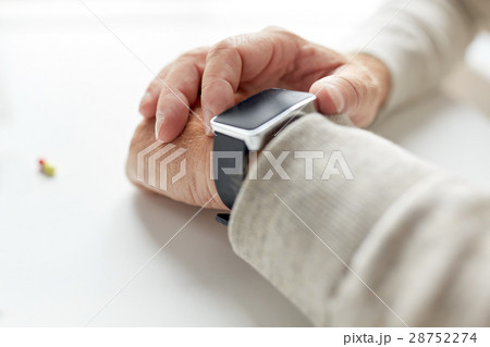 close up of old man hand with pill and smart watch close up of old man hand with pill and smart watch 28752274