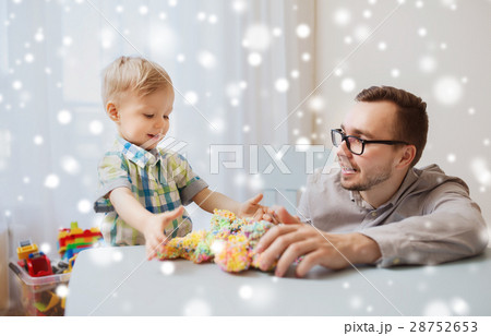 father and son playing with ball clay at home father and son playing with ball clay at home 28752653