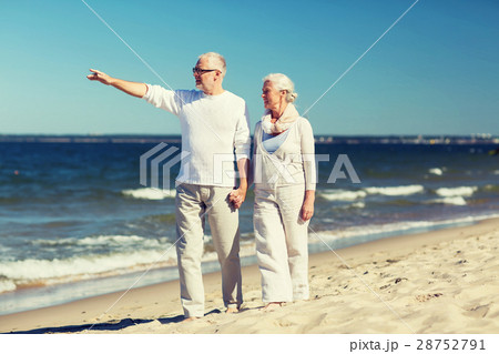 happy senior couple walking on summer beach happy senior couple walking on summer beach 28752791