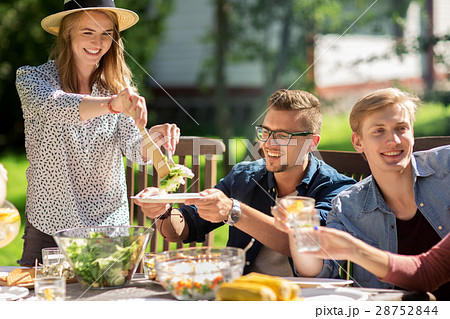 happy friends having dinner at summer garden party happy friends having dinner at summer garden party 28752844