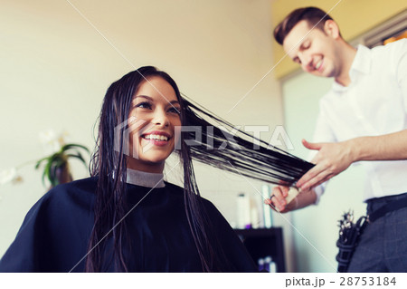 happy woman with stylist cutting hair at salon happy woman with stylist cutting hair at salon 28753184