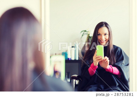 happy young woman at hair salon 28753281