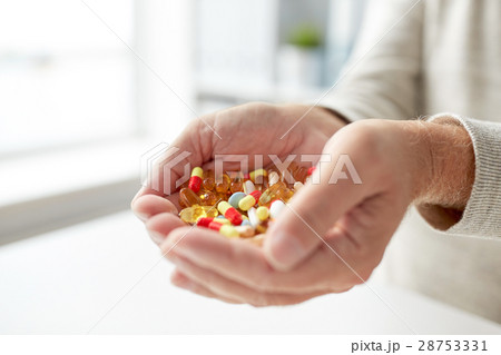 close up of old man hands holding medicine close up of old man hands holding medicine 28753331