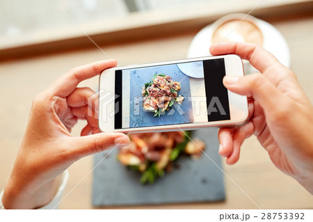 hands with smartphone photographing food 28753392
