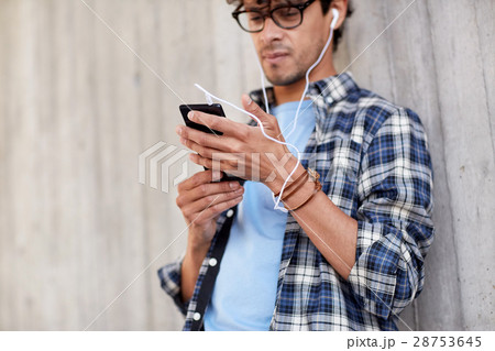 man with earphones and smartphone listening music 28753645
