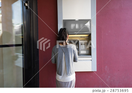 close up of woman at atm machine outdoors close up of woman at atm machine outdoors 28753695