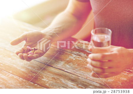 close up of male hands holding pills and water close up of male hands holding pills and water 28753938