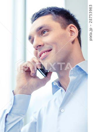 smiling businessman with smartphone in office 28753963