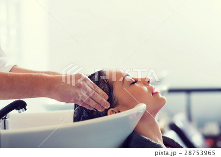happy young woman at hair salon 28753965