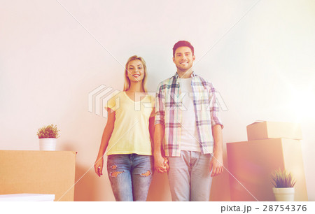 smiling couple with big boxes moving to new home 28754376