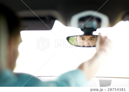 man driving car adjusting rearview mirror man driving car adjusting rearview mirror 28754381