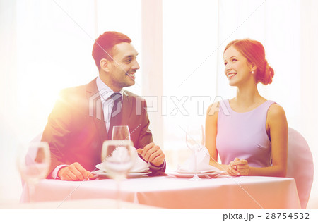 smiling couple looking at each other at restaurant smiling couple looking at each other at restaurant 28754532