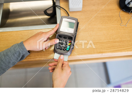close up of hand inserting bank card to terminal 28754829