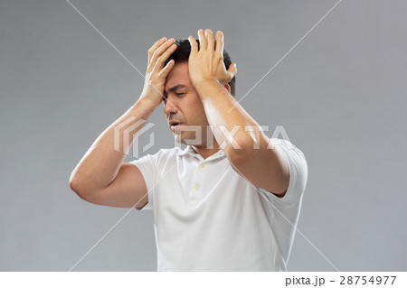 unhappy man suffering from head ache unhappy man suffering from head ache 28754977