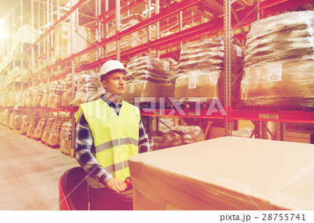man on forklift loading cargo at warehouse man on forklift loading cargo at warehouse 28755741