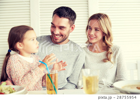 happy family having dinner at restaurant or cafe 28755954