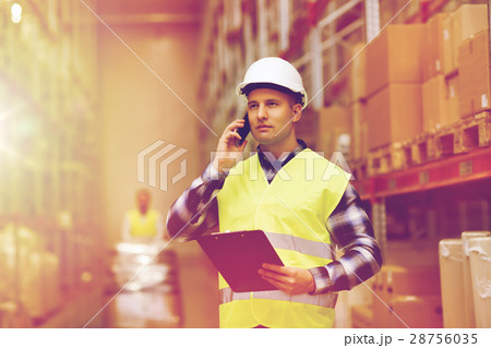 man with clipboard and smartphone at warehouse man with clipboard and smartphone at warehouse 28756035