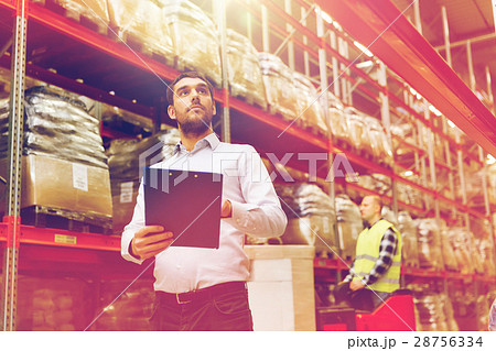 businessman with clipboard at warehouse businessman with clipboard at warehouse 28756334