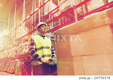 man on forklift loading cargo at warehouse man on forklift loading cargo at warehouse 28756378
