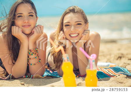 Beautiful young girls drinking water from boutle 28759153