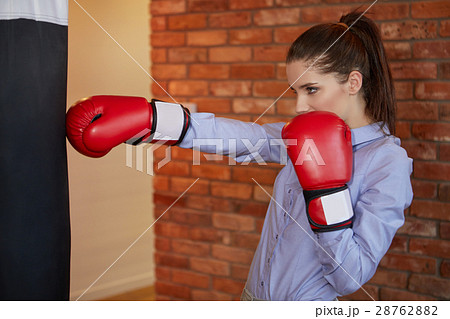 Business woman in red boxing gloves. Fighter concept Business woman in red boxing gloves. Fighter concept 28762882