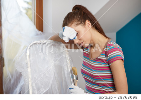 Portrait of female painter near wall before painting. Portrait of female painter near wall before painting. 28763098