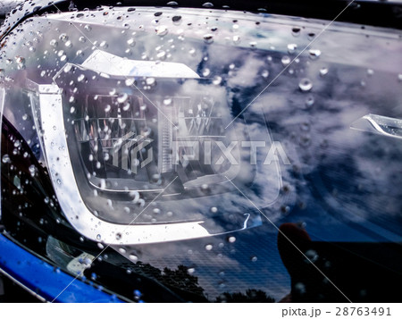Car headlights close up image with rain drops 28763491