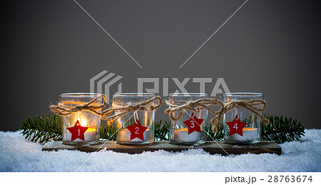 Four Advent candles in the snow Four Advent candles in the snow 28763674