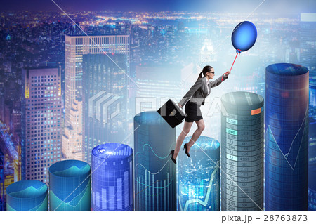 Businesswoman flying on hot balloon over graph 28763873