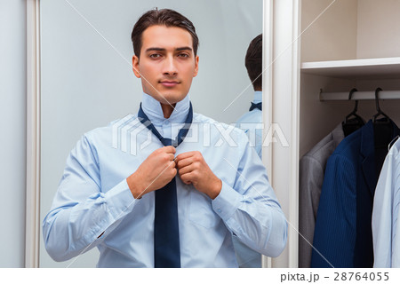 Businessman dressing up for work 28764055